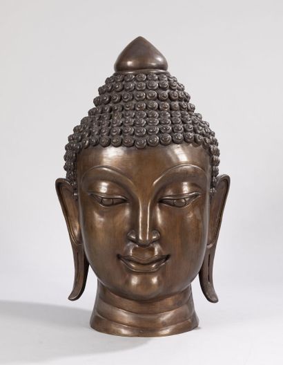 null Sculpture in bronze with a shaded golden-brown patina showing a large Buddha...
