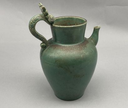 null BIEN HOA. 

Stoneware pitcher with green glaze, the catch in the shape of stylized...