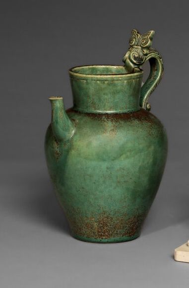 null BIEN HOA. 

Stoneware pitcher with green glaze, the catch in the shape of stylized...