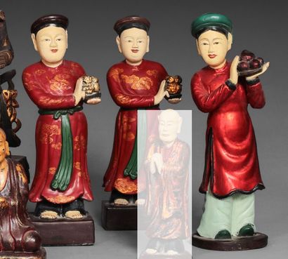 null Three sculptures in polychrome carved wood depicting characters in offering,...