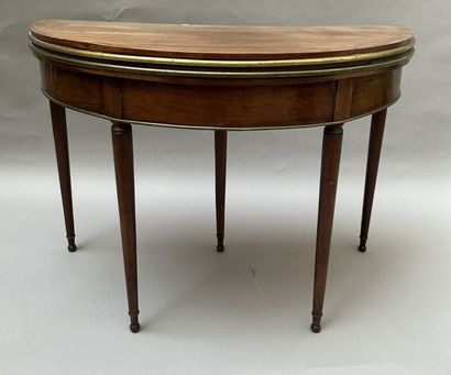 null Mahogany and mahogany veneer half-moon table with a bronze quarter-round and...