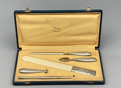 null 
Lot including:

- A silver and ivory metal desk set including: 3 letter openers,...