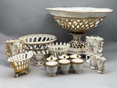 null Lot of shaped pieces in porcelain of Paris with golden highlights on white background...