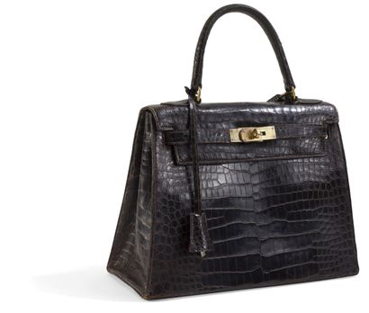 null HERMES
Handbag, Kelly model, in brown crocodile leather (crocodylus porosus*).
Gilded...