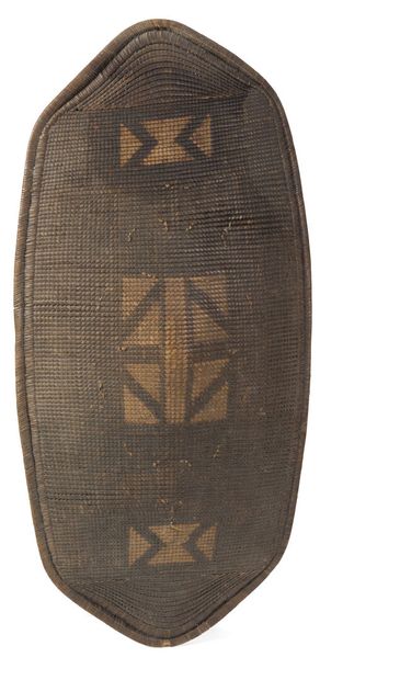 Wood and rattan shield with geometric decoration....