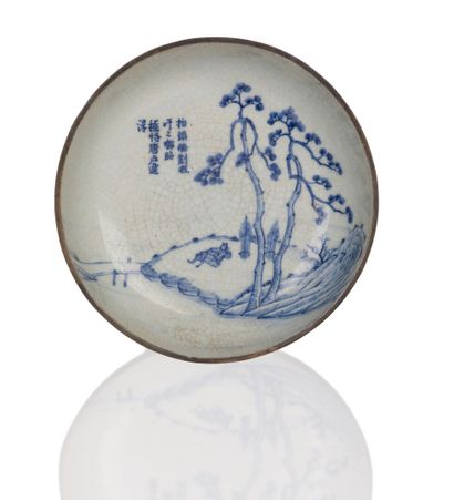 null A blue-white cracked porcelain "Hué blue" dish decorated with a sleeping figure...