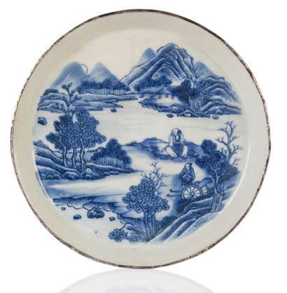 null A Hué blue-white porcelain dish decorated with a lacustrine landscape animated...