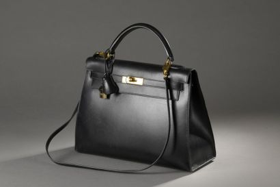 null HERMES. Kelly" bag in black box, golden metal fasteners and clasp, keys under...