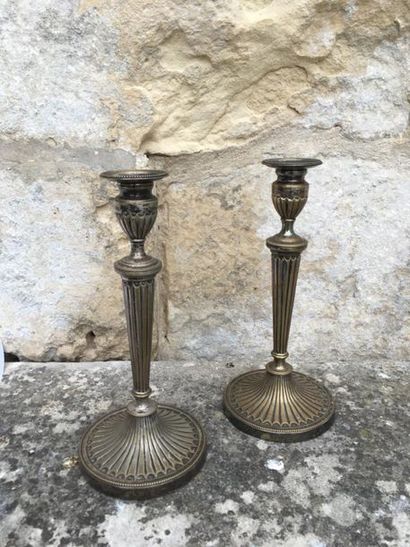 null Pair of Directoire period chased and gilt bronze candleholders with fluted shaft....