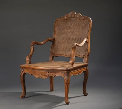 null Moulded and carved wooden armchair from the Louis XV
period. The back and caned...