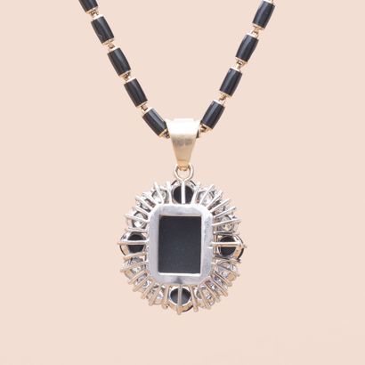 null 
Gold 750 and enamel necklace comprising a square pendant centered with an onyx...