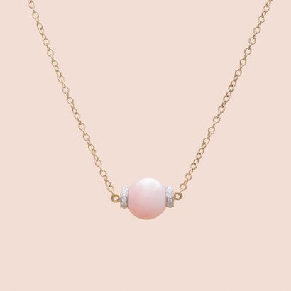 null Necklace in 18K yellow gold with an angel skin coral bead surrounded by round...