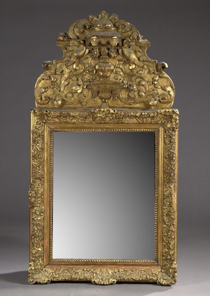 null Glace en bois sculpté et doré en partie du XVIIIe siècle

Le fronton orné d'un...
