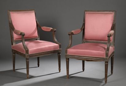 A pair of moulded and carved wooden armchairs,...