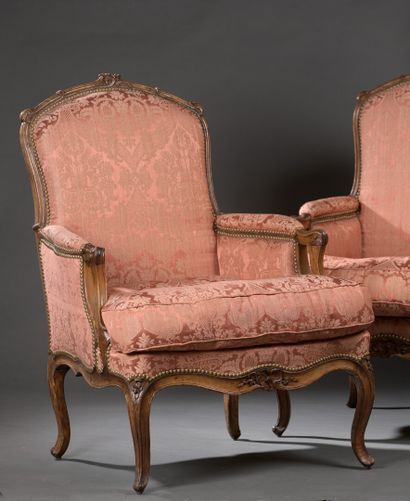 null A pair of moulded and carved walnut bergères, attributed to Tilliard, Louis...