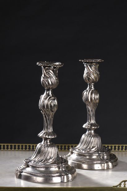 null A pair of Louis XV period metal candlesticks

The shaft with curved baluster....