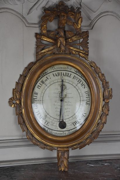 null A Louis XVI period molded, carved and gilded wood barometer by the house of...