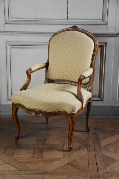 null A suite of three Louis XV period moulded and carved natural wood flat-back armchairs...