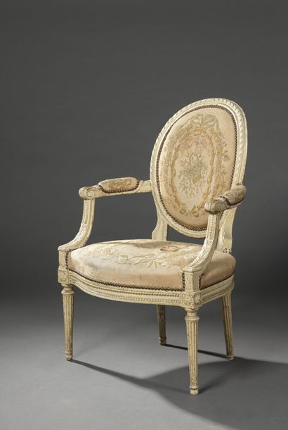 null A Louis XVI period moulded, carved and relacquered (over gilding) wooden armchair...