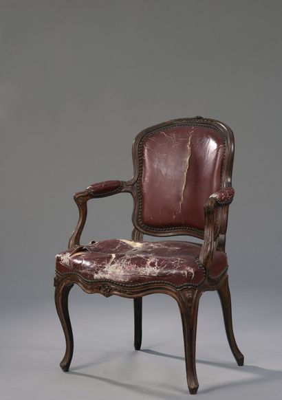 null A Louis XV period moulded and finely carved wooden armchair stamped M. Cresson.

With...