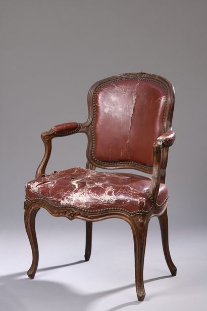 null A Louis XV period moulded and finely carved wooden armchair stamped M. Cresson.

With...