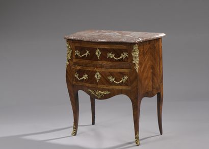 null A Louis XV period small chest of drawers in violet wood veneer and light wood...