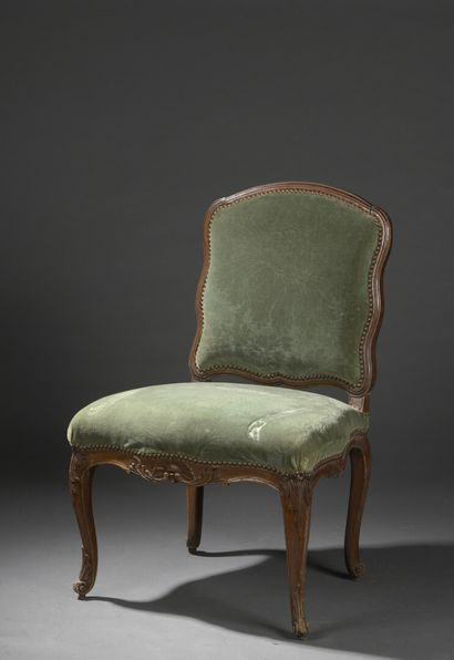 A molded and carved wooden chair stamped...