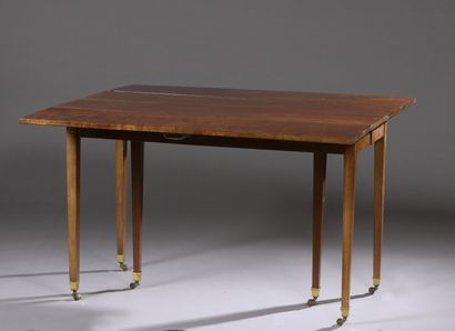 null Mahogany and mahogany veneer table, early 19th century

It rests on six sheath...