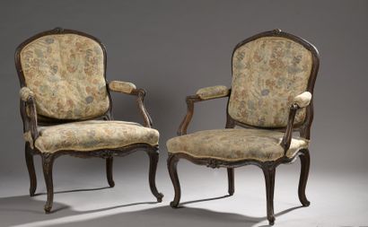 A pair of moulded and carved wooden armchairs...