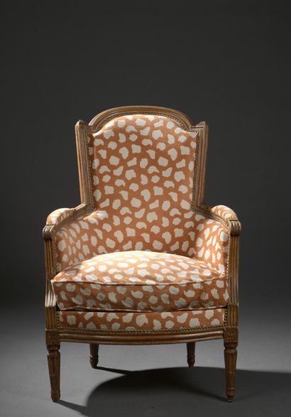 null A molded and carved wood cabriolet armchair stamped by Claude JAVOY from the...
