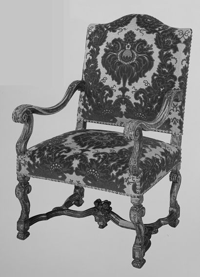  A Louis XIV period moulded and carved wood armchair with a flat back. 
It rests...