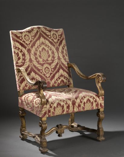  A Louis XIV period moulded and carved wood armchair with a flat back. 
It rests...