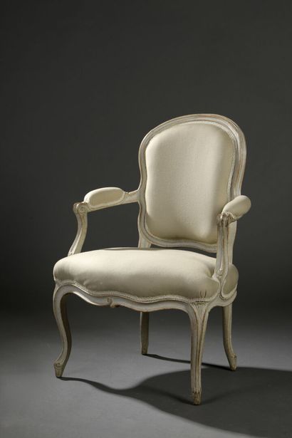 Armchair in molded and carved wood stamped...
