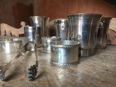 null Lot of five silver goblets.

Three silver napkin rings and a silver sugar tongs...