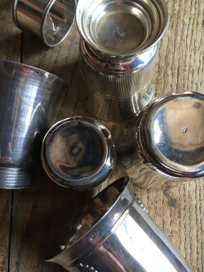 null Lot of five silver goblets.

Three silver napkin rings and a silver sugar tongs...