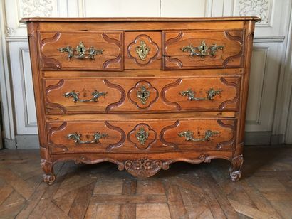 A molded and carved wooden chest of drawers...