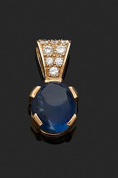 Pendant adorned with an oval sapphire cut...