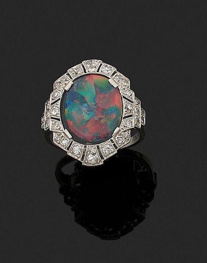 null Ring of the 1920s decorated with an oval black opal in a surround of diamonds...