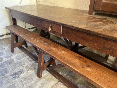 Large farm table in natural wood opening...