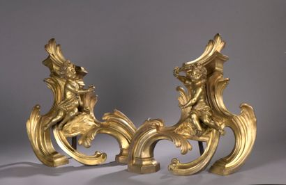 null Pair of chased and gilt bronze andirons in the Louis XV style, 19th century

Decorated...