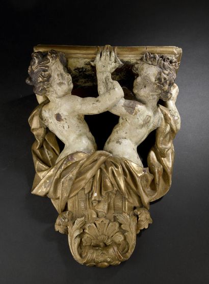 null Louis XIV period carved and gilded wood console
Decorated with two cherubs supporting...