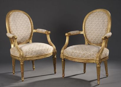Pair of molded, carved and gilded wood armchairs...