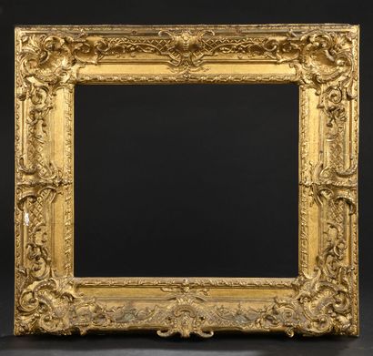 Frame in molded wood, carved and gilded,...