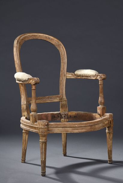 Louis XVI period molded and carved wood armchair...