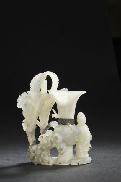 null Pale celadon jade GROUP 
CHINA, 18th-19th century
Carved with a woman standing...