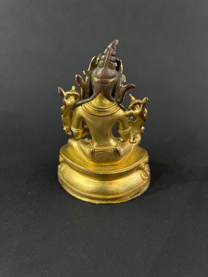 null Asia
Small ormolu Buddhist divinity
H.9,5 cm