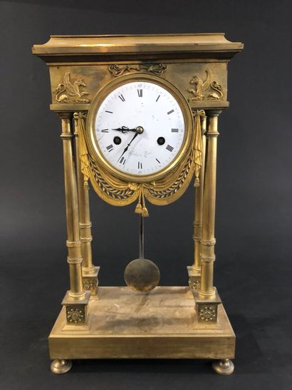 null Empire-period gilt and chased bronze portico clock.
The dial signed Greber in...