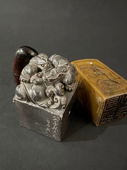 null China - Three small seals, two in carved stone decorated with chimeras or landscapes...