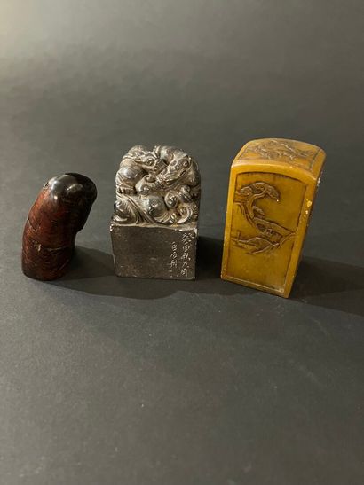 null China - Three small seals, two in carved stone decorated with chimeras or landscapes...