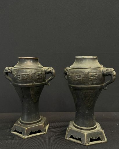 null CHINA - Late 19th century. 
GARNITURE comprising: two baluster vases, side handles...